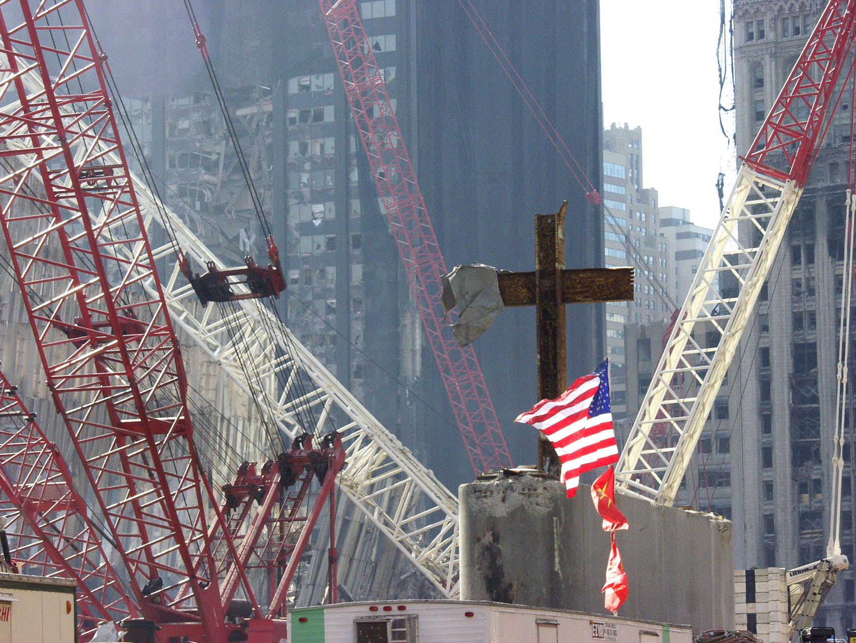 WTC clean up site - Beams in shape of cross with USA Flag flying in the forground