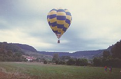 Balloon flying over a valley